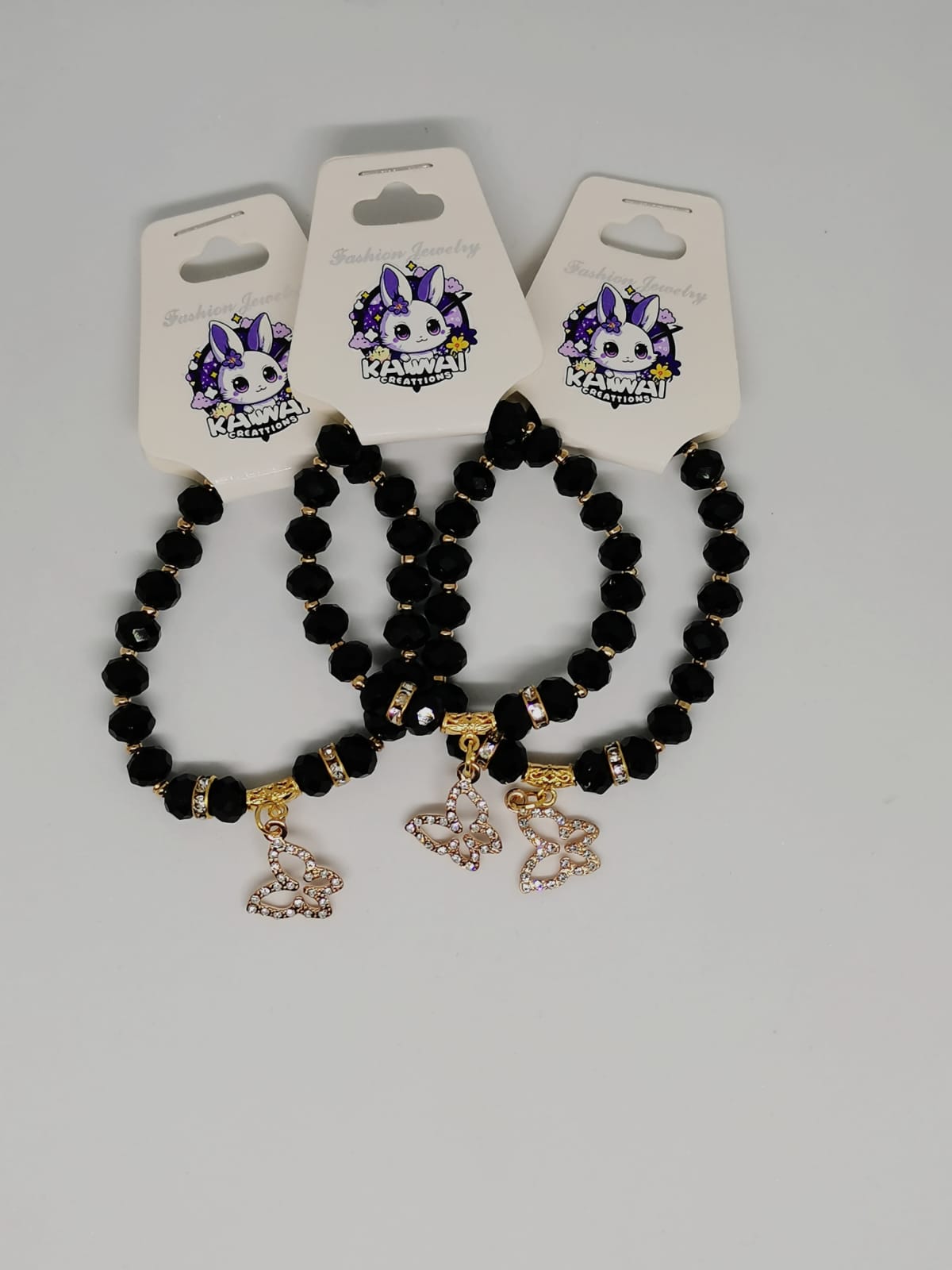 Black crystal and gold butterfly charm bracelet