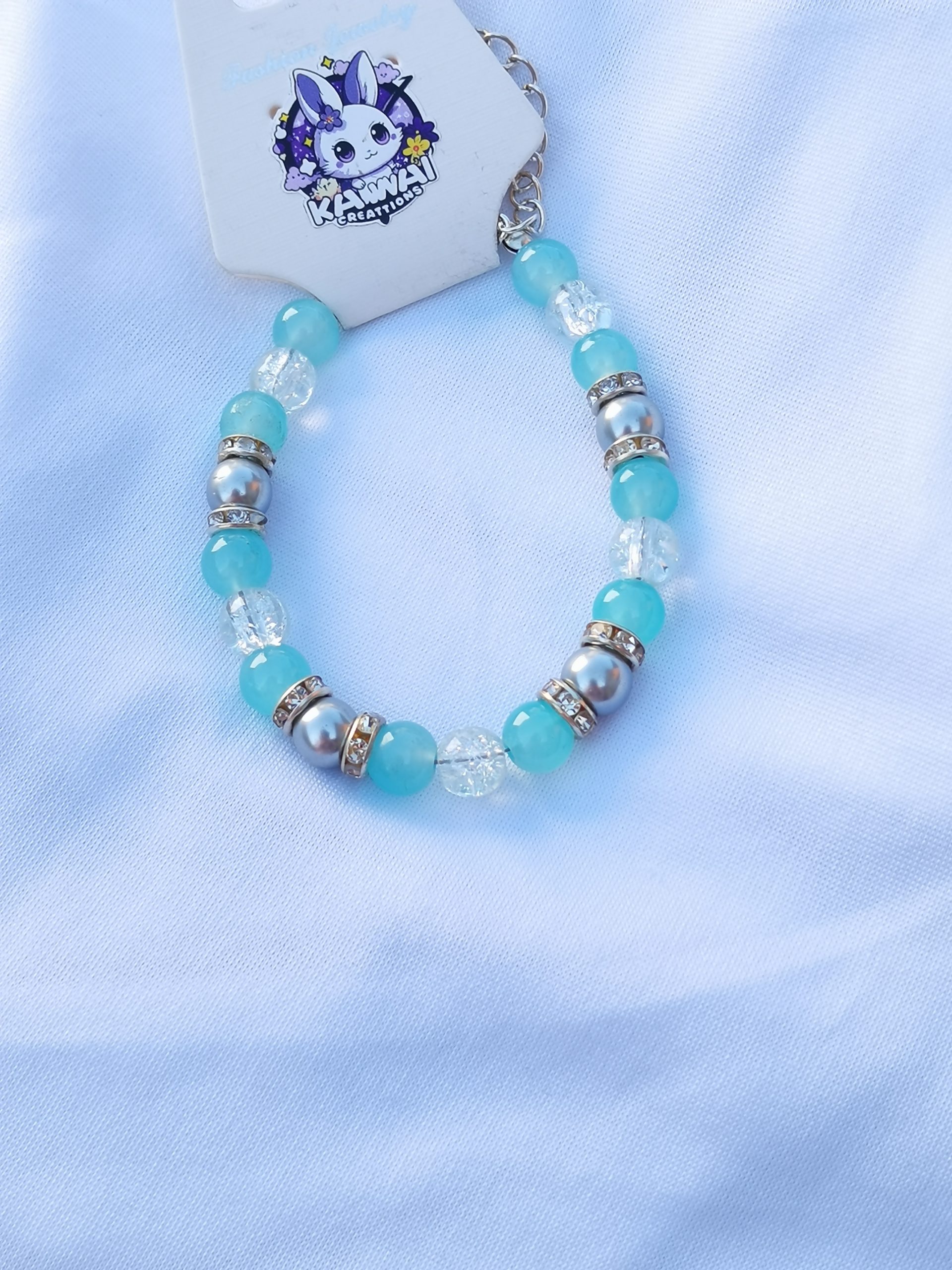 Grey pearl with clear crack and solid aqua bead adjustable bracelet